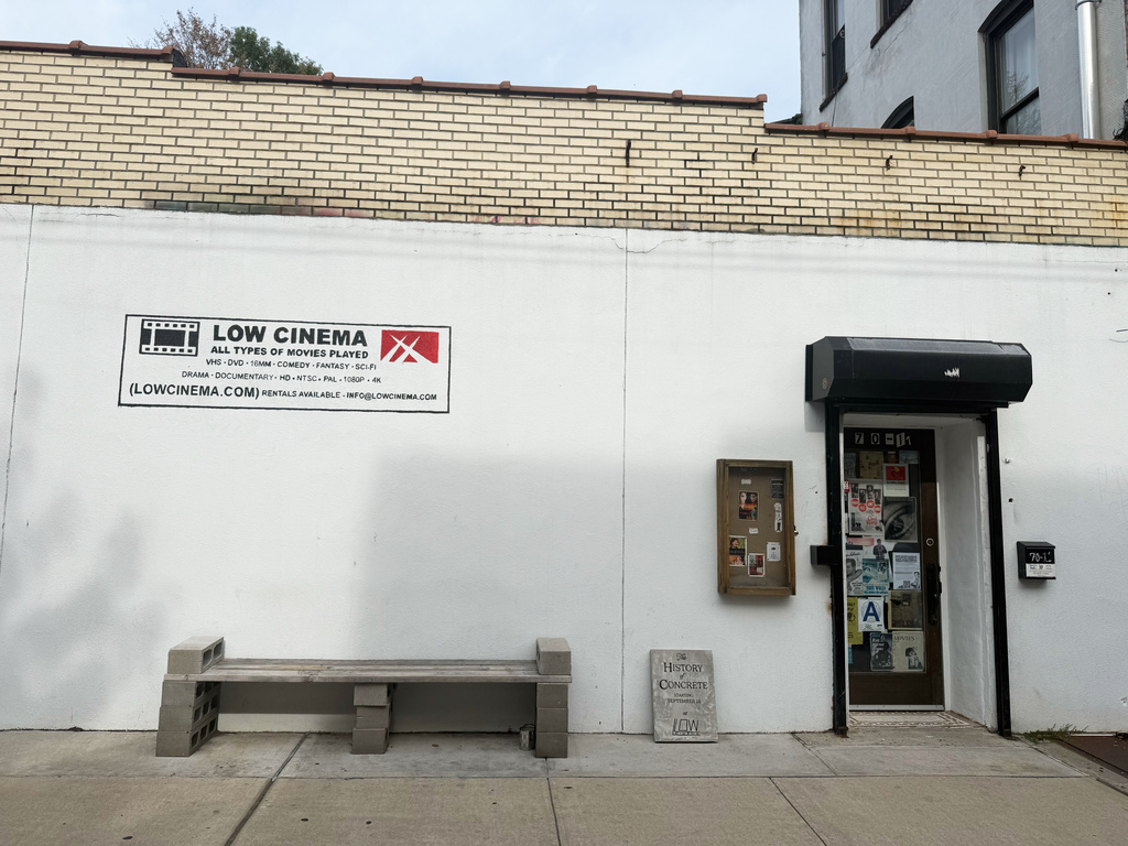 In this photo taken with a smartphone, signage for "The History of Concrete" is pictured outside the Low Cinema on Tuesday, Sept. 8, 2026, in the Ridgewood section of Queens borough of New York. (AP Photo/Jake Coyle)