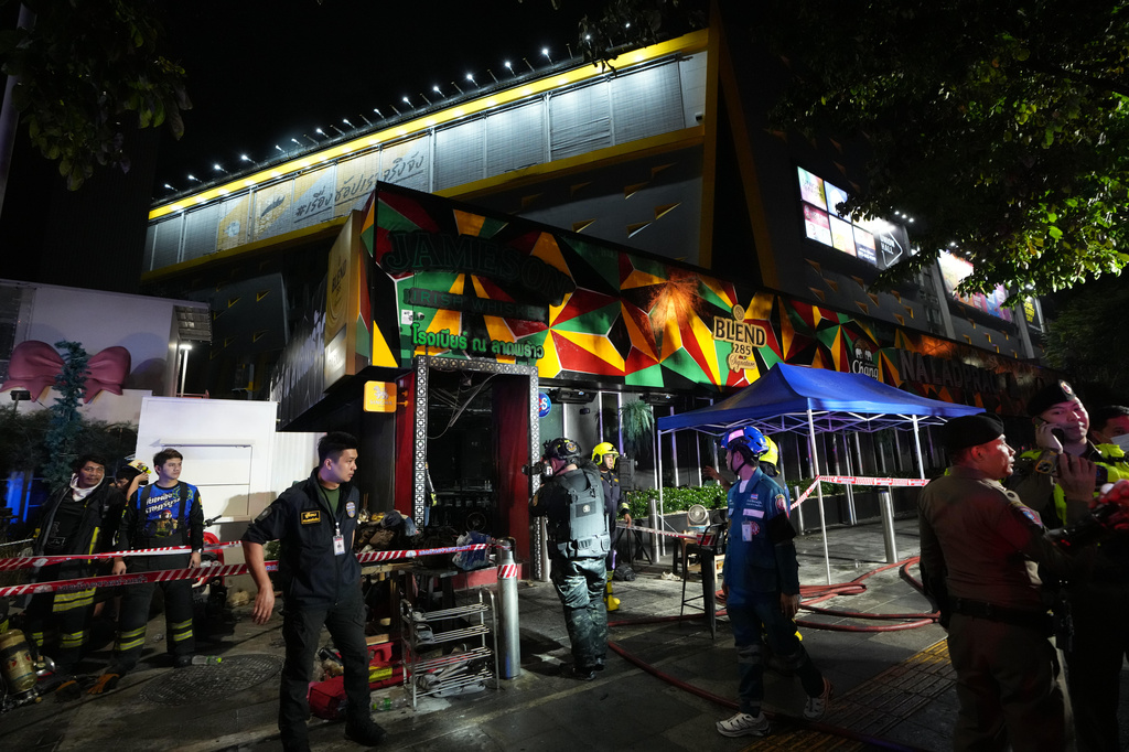 Rescuers stand near the site of a fire in Bangkok, Thailand, Monday, July 13, 2026. (AP Photo/Sakchai Lalit)