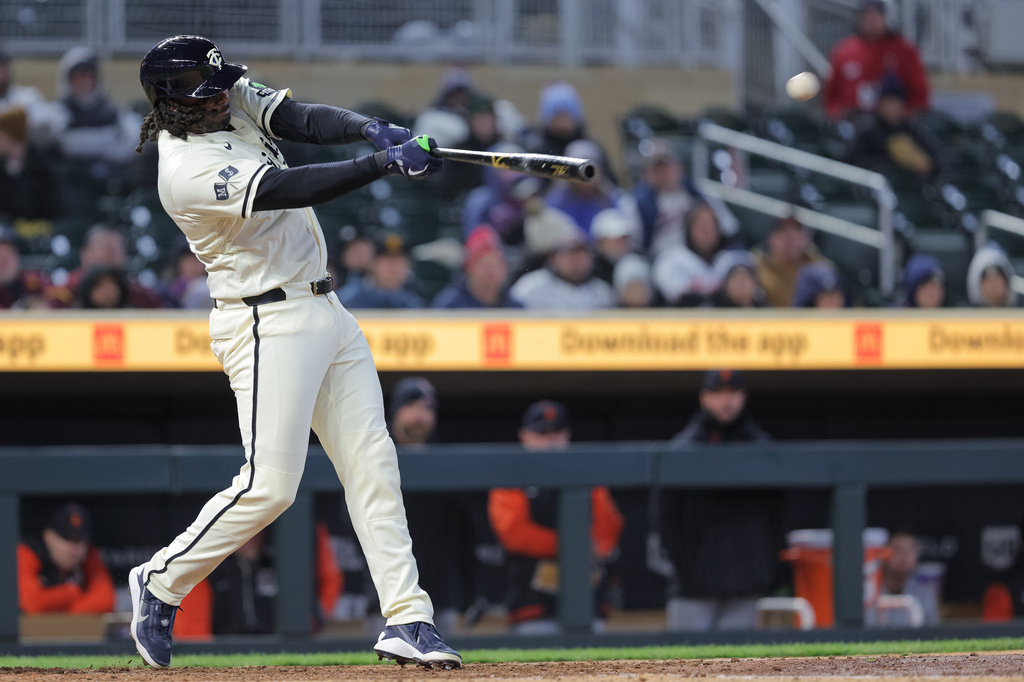 Minnesota Twins designated hitter Josh Bell hits an RBI-double during the fifth inning of a baseball game against the Detroit Tigers, Tuesday, April 7, 2026, in Minneapolis. (AP Photo/Bailey Hillesheim)