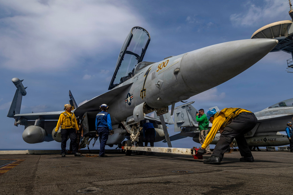 This photo provided by the U.S. Navy shows sailors preparing a Boeing EA-18G Growler on the flight deck of the Nimitz-class aircraft carrier USS Abraham Lincoln in the Indian Ocean on Jan. 21, 2026. (Mass Communication Specialist Seaman Daniel Kimmelman/U.S. Navy via AP)