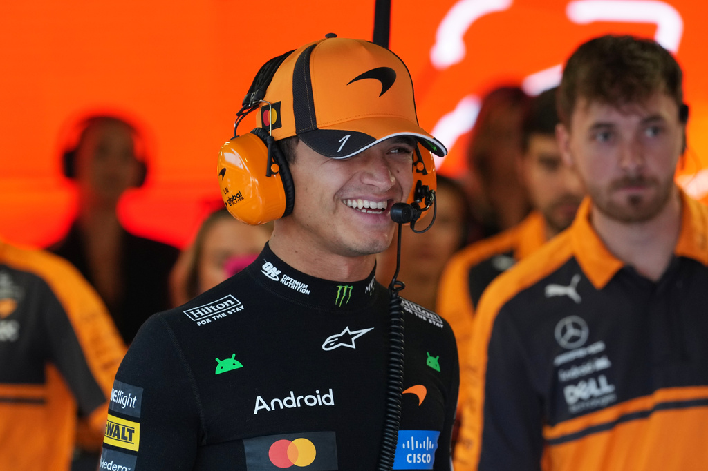 McLaren driver Lando Norris of Britain smiles in his garage during the third free practice ahead of the Italian Formula One Grand Prix, in Monza, Italy, Saturday, Sept. 5, 2026. (AP Photo/Antonio Calanni)