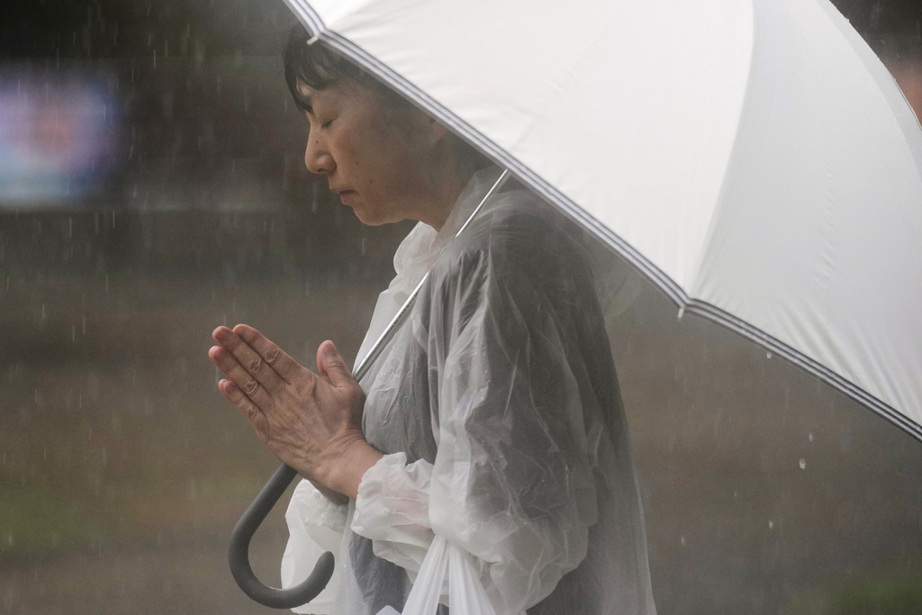 A person prays ahead of a ceremony to mark the 80th anniversary of the WWII U.S. atomic bombing at Atomic Bomb Hypocenter Park in Nagasaki, Japan, Aug. 9, 2025. (AP Photo/Eugene Hoshiko)