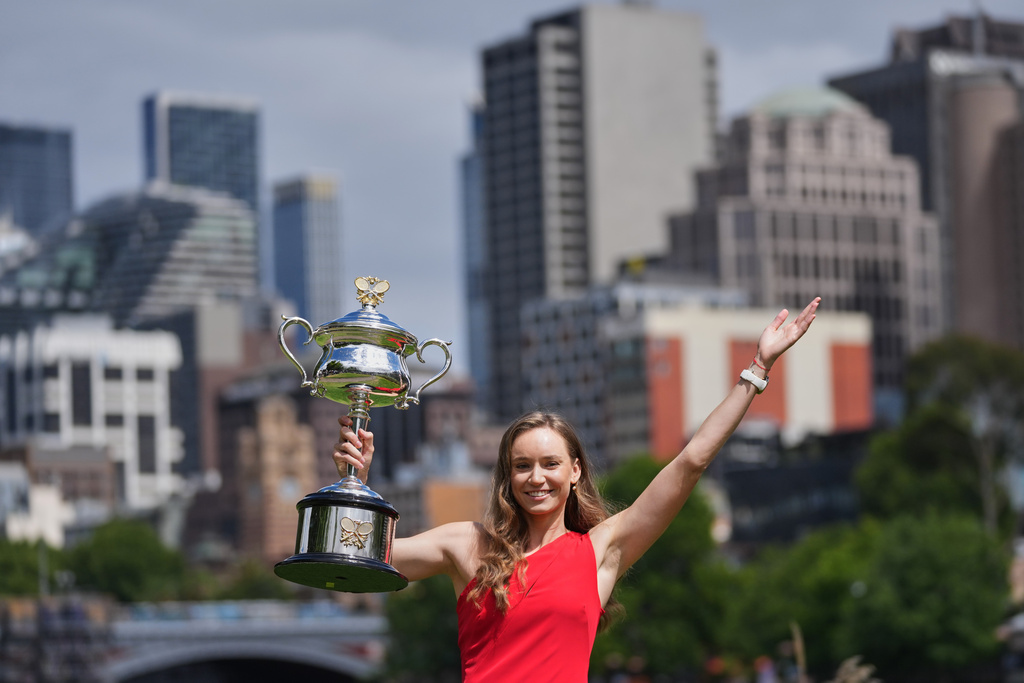 Elena Rybakina of Kazakhstan poses with Daphne Akhurst Memorial Cup on the banks of the Yarra River the morning after defeating Aryna Sabalenka of Belarus in the women's singles final at the Australian Open tennis championship in Melbourne, Australia, Sunday, Feb. 1, 2026. (AP Photo/Dita Alangkara)