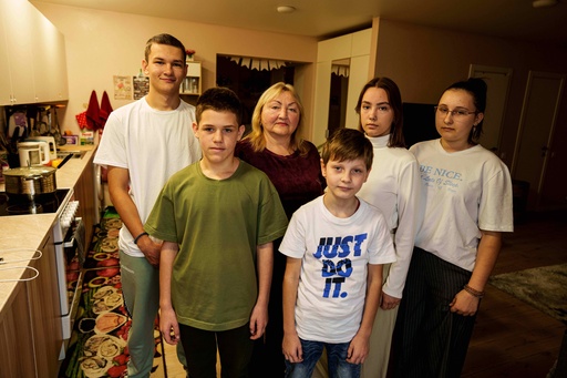 From left, Mykyta Bogomol, 16, Ivan, 12, mother Natalia, Oleksandr 9, Sofia, 17, and Lilia 15, pose at their home in Hansen Village complex in Tarasivka, Ukraine, Thursday, Oct. 2, 2025. (AP Photo/Evgeniy Maloletka) From left, Mykyta Bogomol, 16, Ivan, 12, mother Natalia, Oleksandr 9, Sofia, 17, and Lilia 15, pose at their home in Hansen Village complex in Tarasivka, Ukraine, Thursday, Oct. 2, 2025. (AP Photo/Evgeniy Maloletka)