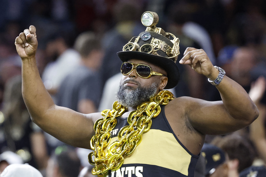 A New Orleans Saints fan cheers on the team during the first half of an NFL football game against the Arizona Cardinals Sunday, Sept. 7, 2025, in New Orleans. (AP Photo/Butch Dill)