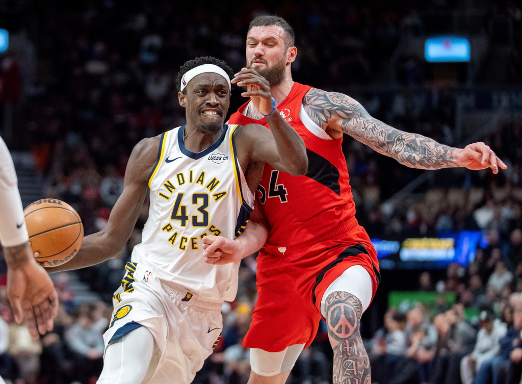 Indiana Pacers forward Pascal Siakam (43) drives past Toronto Raptors forward Sandro Mamukalashvili, right, during first-half NBA basketball game action in Toronto, Sunday Feb. 8, 2026. (Frank Gunn/The Canadian Press via AP)