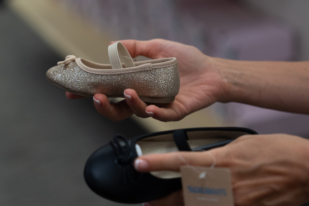 Khrystyna Lialina shops for shoes for her daughter at a JCPenney store in Glendale, Calif., Tuesday, Aug. 11, 2026. (AP Photo/Jae C. Hong)