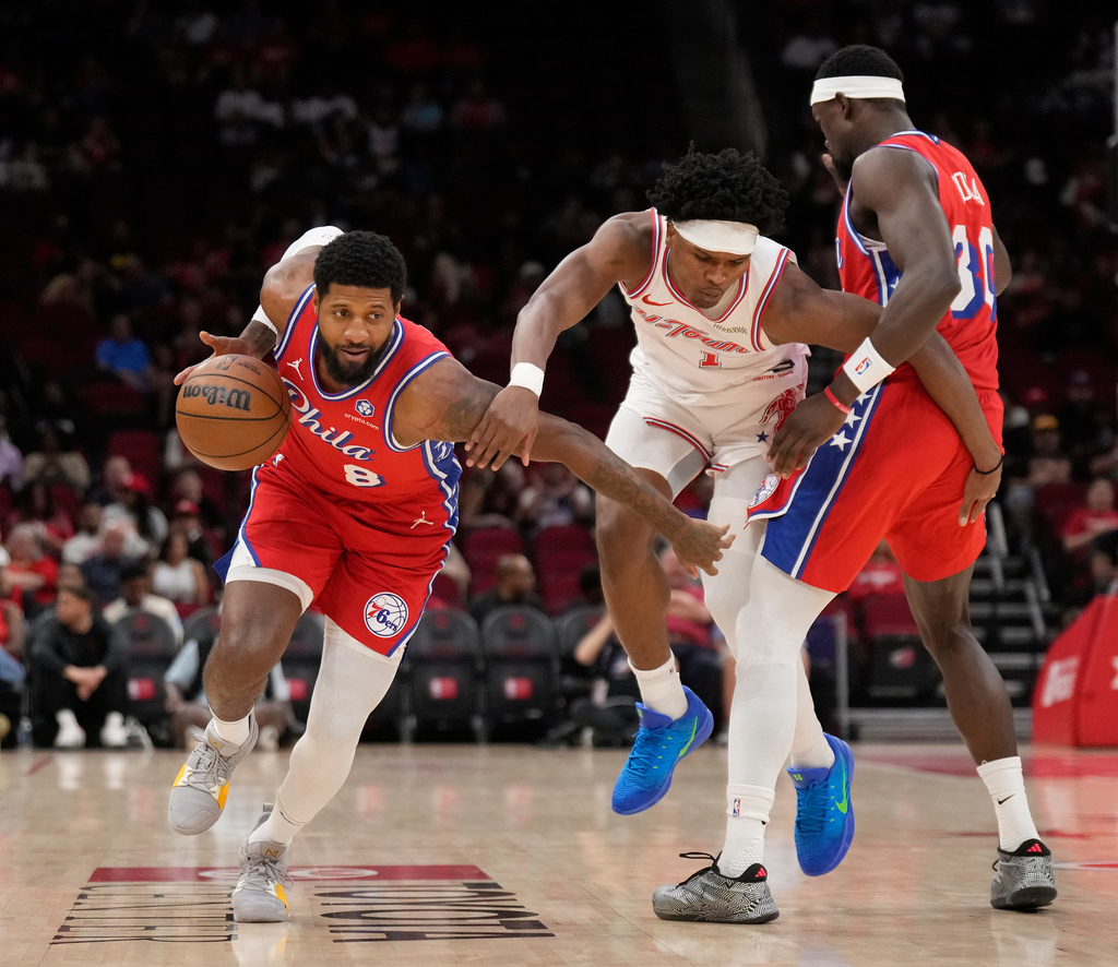 Philadelphia 76ers forward Paul George (8) controls the ball against Houston Rockets guard Amen Thompson (1) who is defended by 76ers center Adem Bona (30) during the first half of an NBA basketball game, Thursday, April 9, 2026, in Houston. (AP Photo/ Karen Warren)