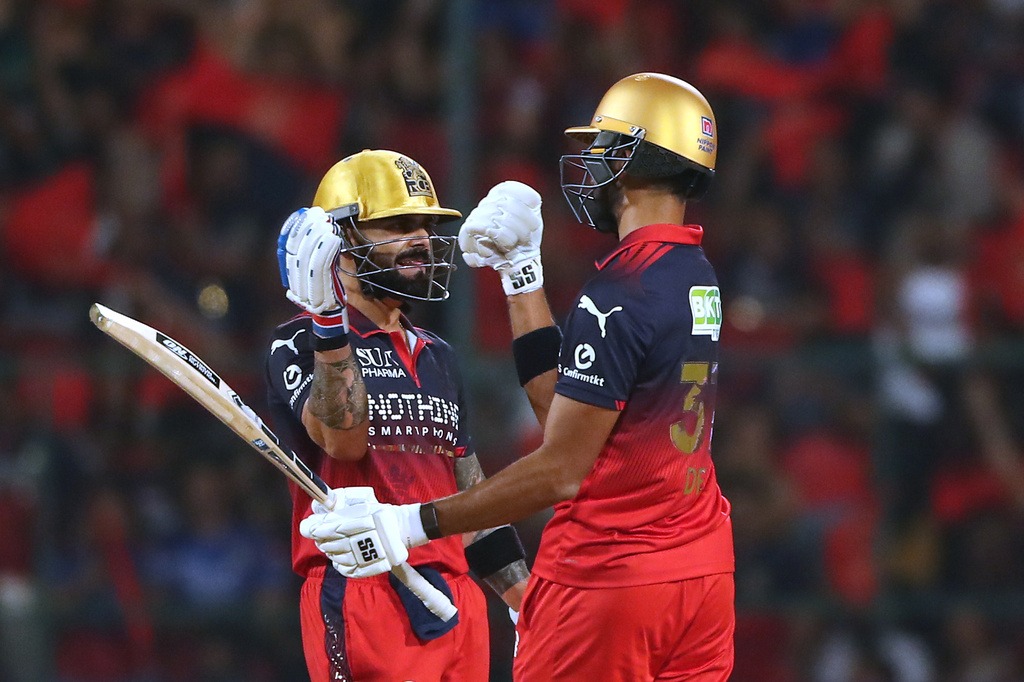 Royal Challengers Bengaluru's Virat Kohli celebrates his fifty runs with batting partner Devdutt Padikkal during the Indian Premier League cricket match between Royal Challengers Bengaluru and Gujarat Titans in Bengaluru, India, Friday, April 24, 2026. (AP Photo)