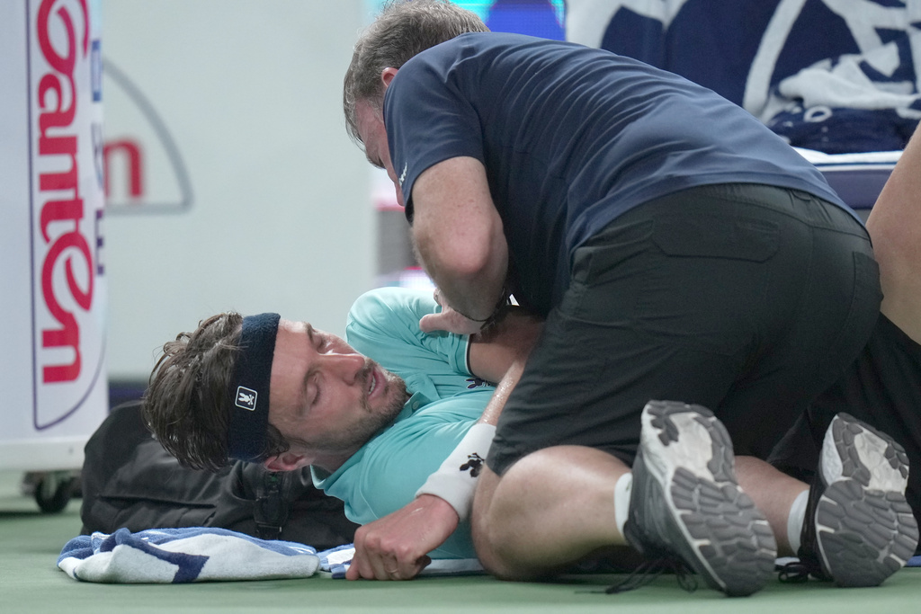 Arthur Rinderknech of France is attended to by a trainer, as he plays against Valentin Vacherot of Monaco during the final of the Shanghai Masters tennis tournament at Qizhong Forest Sports City Tennis Center, in Shanghai, China, Sunday, Oct. 12, 2025. (AP Photo/Andy Wong)