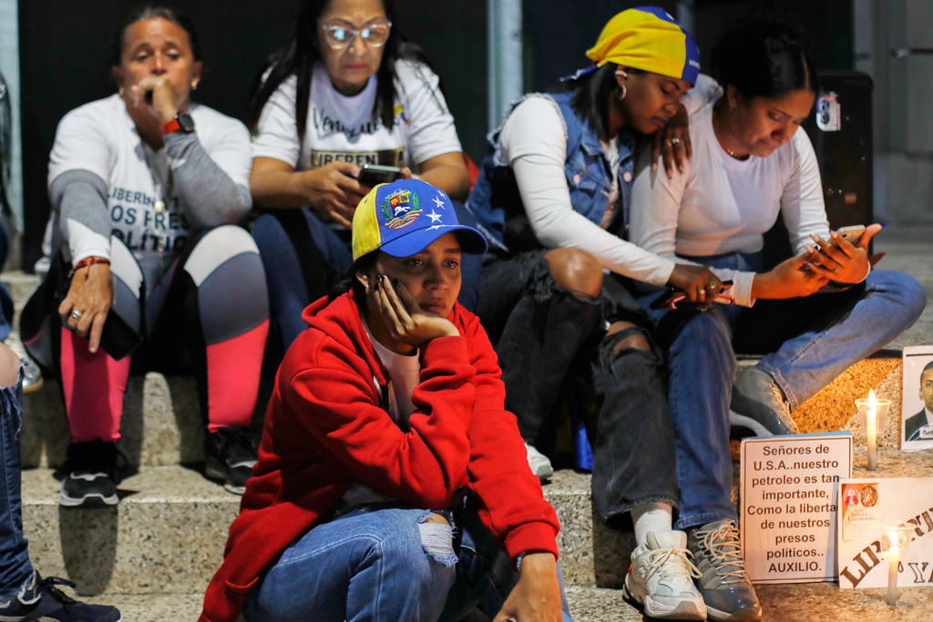 Relatives of detainees they say are held for political reasons wait outside El Helicoide, the headquarters of Venezuela's intelligence service and a detention center, after the National Assembly approved an amnesty bill in Caracas, Venezuela, Thursday, Feb. 19, 2026. (AP Photo/Crisitian Hernandez)