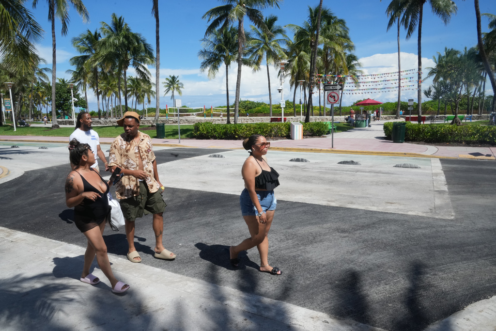 Pedestrians walk over a crosswalk on Miami Beach's iconic Ocean Drive that used to be rainbow-colored celebrating the history and contributions of the LGBTQ+ community, Monday, Oct. 6, 2025. (AP Photo/Marta Lavandier)
