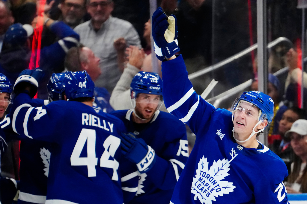 Toronto Maple Leafs' Troy Stecher, right, celebrates after his goal against the New York Rangers during the third period of an NHL hockey game in Toronto, Thursday, Oct. 22, 2026. (Frank Gunn/The Canadian Press via AP)