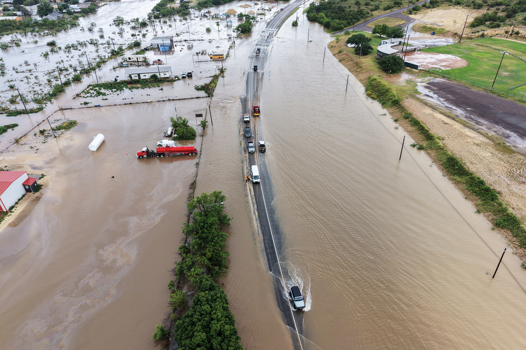 An aerial view shows flooding on Friday, July 17, 2026, in Ozona, Texas. (AP Photo/Gerald Herbert)