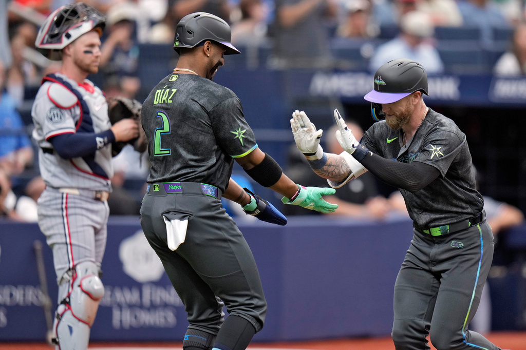 Tampa Bay Rays' Jake Fraley celebrates with Yandy Díaz (2) after Fraley hit a two-run home run off Minnesota Twins pitcher Bailey Ober during the fourth inning of a baseball game Saturday, April 25, 2026, in St. Petersburg, Fla. (AP Photo/Chris O'Meara)