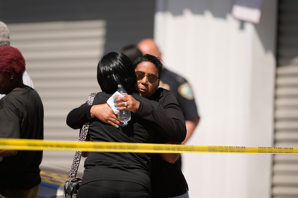 Council woman Tabatha Taylor, right, hugs an unknown person outside the scene of a mass shooting in Shreveport, La., Sunday, April 19, 2026. (AP Photo/Gerald Herbert)