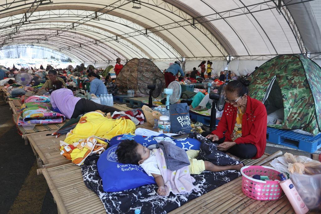 Thai residents who fled homes as Thailand and Cambodia clash over border, rest at an evacuation center in Buriram province, Thailand, Monday, Dec. 8, 2025. (AP Photo/Sopa Saelee)