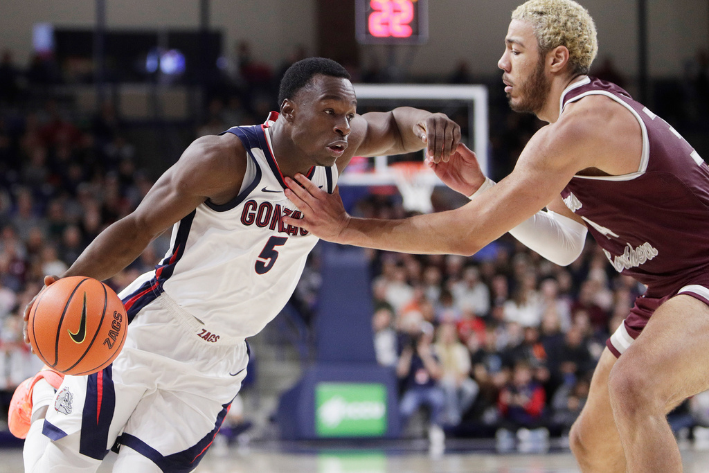 Gonzaga forward Emmanuel Innocenti (5) drives while pressured by Texas Southern center Jordan Gorecki, right, during the first half of an NCAA college basketball game, Monday, Nov. 3, 2025, in Spokane, Wash. (AP Photo/Young Kwak)