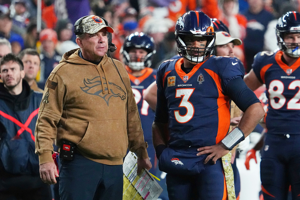 FILE - Denver Broncos head coach Sean Payton and quarterback Russell Wilson (3) look on during a timeout in an NFL football game against the Minnesota Vikings, Nov. 19, 2023, in Denver. (AP Photo/Bart Young, File)