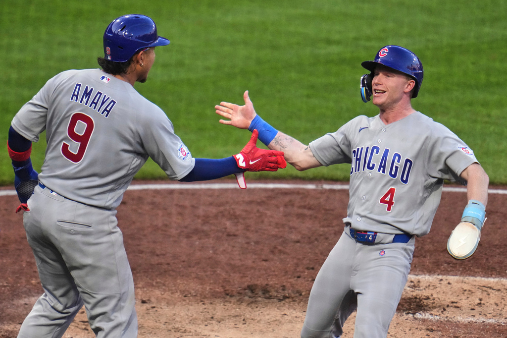 Chicago Cubs' Pete Crow-Armstrong (4) and Miguel Amaya (9) celebrate after scoring on a single by Seiya Suzuki off Pittsburgh Pirates pitcher Paul Skenes during the fifth inning of a baseball game in Pittsburgh, Saturday, July 25, 2026. (AP Photo/Gene J. Puskar)