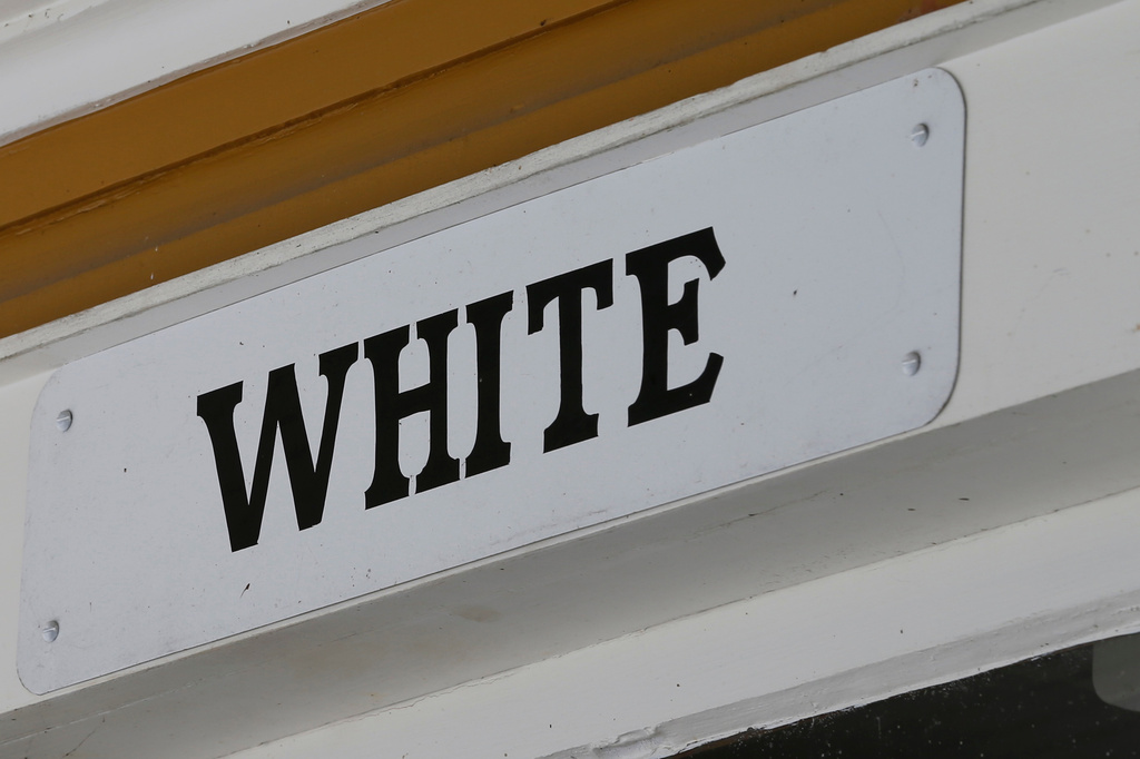 FILE - A sign indicates the white entrance at the Montpelier Train Depot segregation exhibit in Orange, Va. Jan. 27, 2016. (AP Photo/Steve Helber, File)