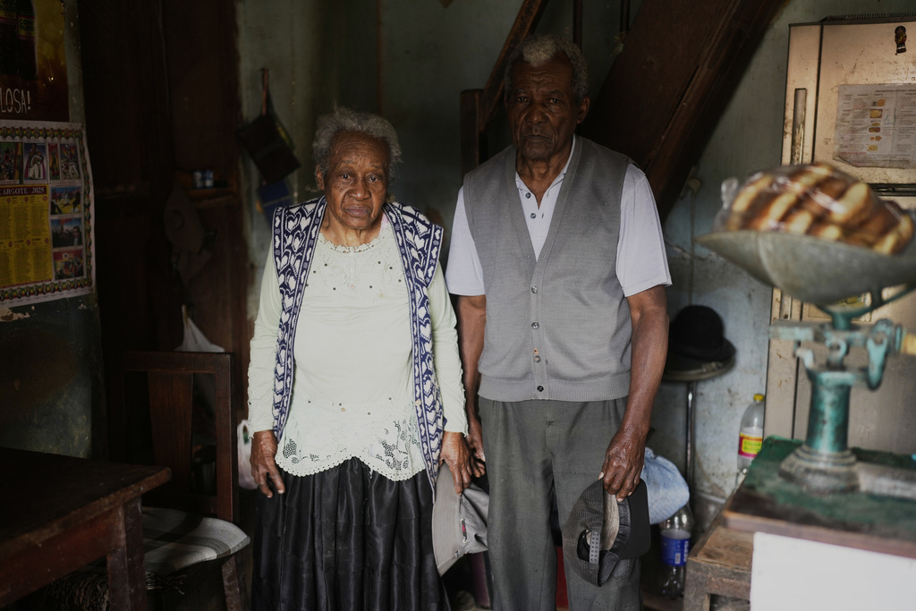 Julio Pinedo, a symbolic leader regarded as the king of the Afro-Bolivians, and his wife Angelica Larrea, pose for a photo in their home in Mururata, Bolivia, Sunday, Aug. 3, 2025. (AP Photo/Juan Karita)