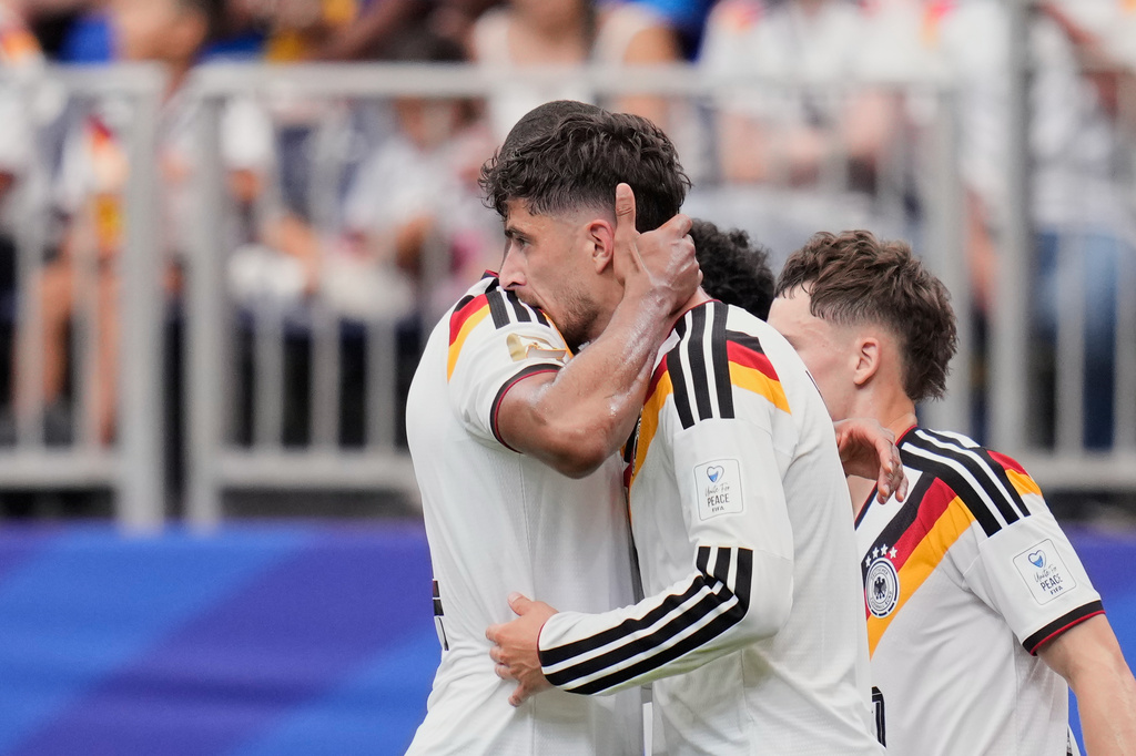 Germany's Kai Havertz celebrates with teammate Jonathan Tah, left, after scoring his side's third goal during the World Cup Group E soccer match between Germany and Curacao in Houston, Sunday, June 14, 2026. (AP Photo/Karen Warren)
