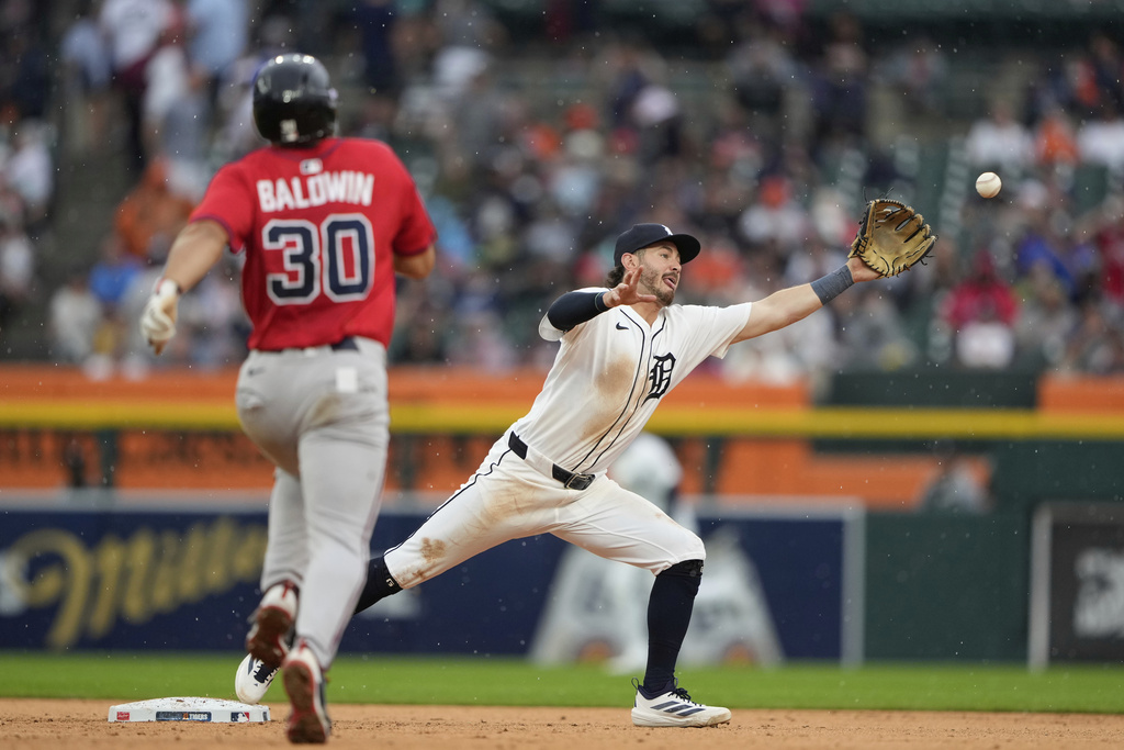 Detroit Tigers third baseman Zach McKinstry, right, catches a pass from first baseman Spencer Torkelson to force out Atlanta Braves' Drake Baldwin at second during the seventh inning of a baseball game, Sunday, Sept. 21, 2025, in Detroit. (AP Photo/Ryan Sun)