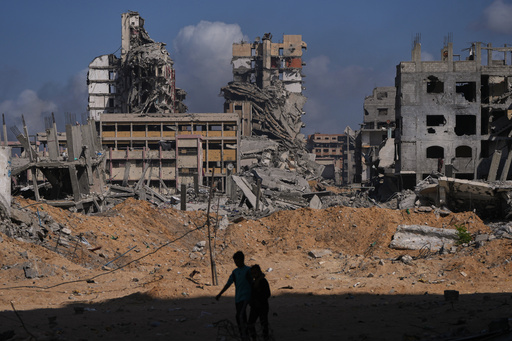 Palestinians walk through the destruction caused by the Israeli air and ground offensive in the Al-Shati camp, in Gaza City, Friday, Oct. 24, 2025. (AP Photo/Abdel Kareem Hana) Palestinians walk through the destruction caused by the Israeli air and ground offensive in the Al-Shati camp, in Gaza City, Friday, Oct. 24, 2025. (AP Photo/Abdel Kareem Hana)