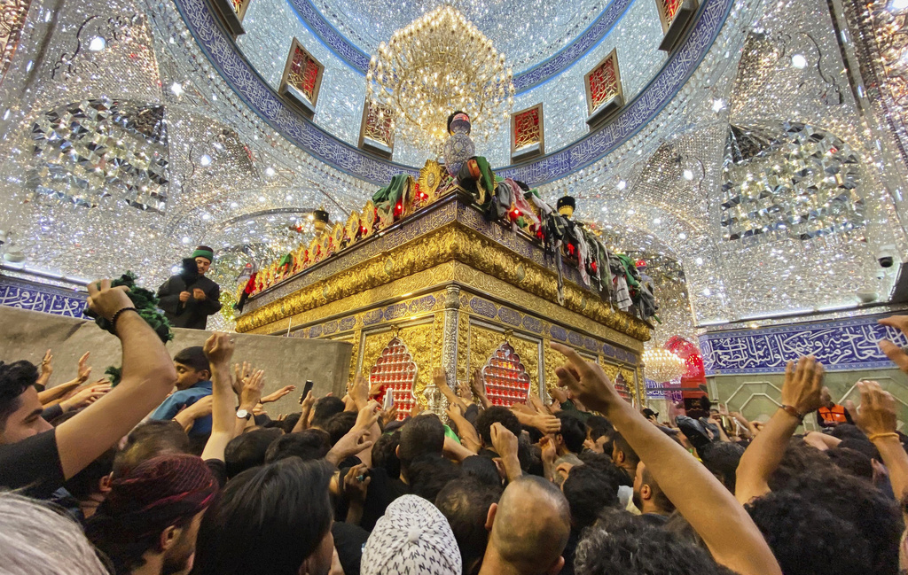 Shiite pilgrims mark the holiday of Arbaeen inside the holy shrine of Imam Abbas, which marks the end of the 40-day mourning period following Ashura, in Karbala, Iraq, Thursday, Aug. 15, 2025. (AP Photo/Hadi Mizban)