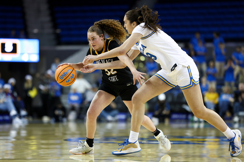 Long Beach State guard Brynna Pukis, left, drives against UCLA guard Lena Bilić, right, during the first half of an NCAA college basketball game, Saturday, Dec. 20, 2025, in Los Angeles. (AP Photo/Jessie Alcheh)