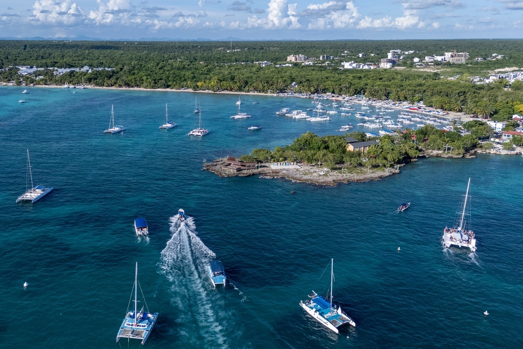 Boats maneuver off the coast of Bayahibe, Dominican Republic on Oct. 17, 2025. (AP Photo/Francesco Spotorno)