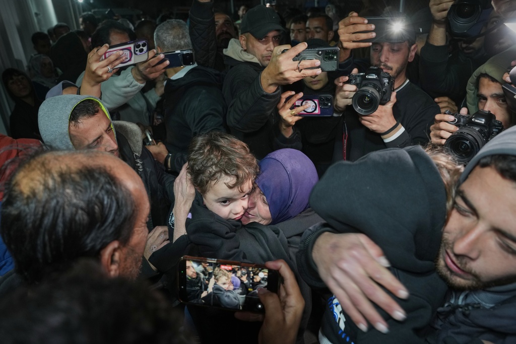 Najat Rubaie, center right, embraces one of her grandsons after they arrive with their mother as part of a group of about a dozen Palestinian returnees allowed into Gaza following the long-awaited reopening of the Rafah border crossing, at Nasser Hospital in Khan Younis, southern Gaza Strip, early Tuesday, Feb. 3, 2026. (AP Photo/Abdel Kareem Hana)