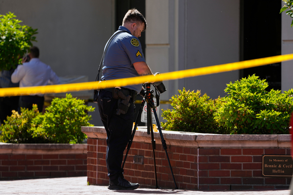 A Sheriff's deputy investigates a shooting scene outside the Montgomery County Courthouse, Wednesday, May 13, 2026, in Clarksville, Tenn. (AP Photo/George Walker IV)