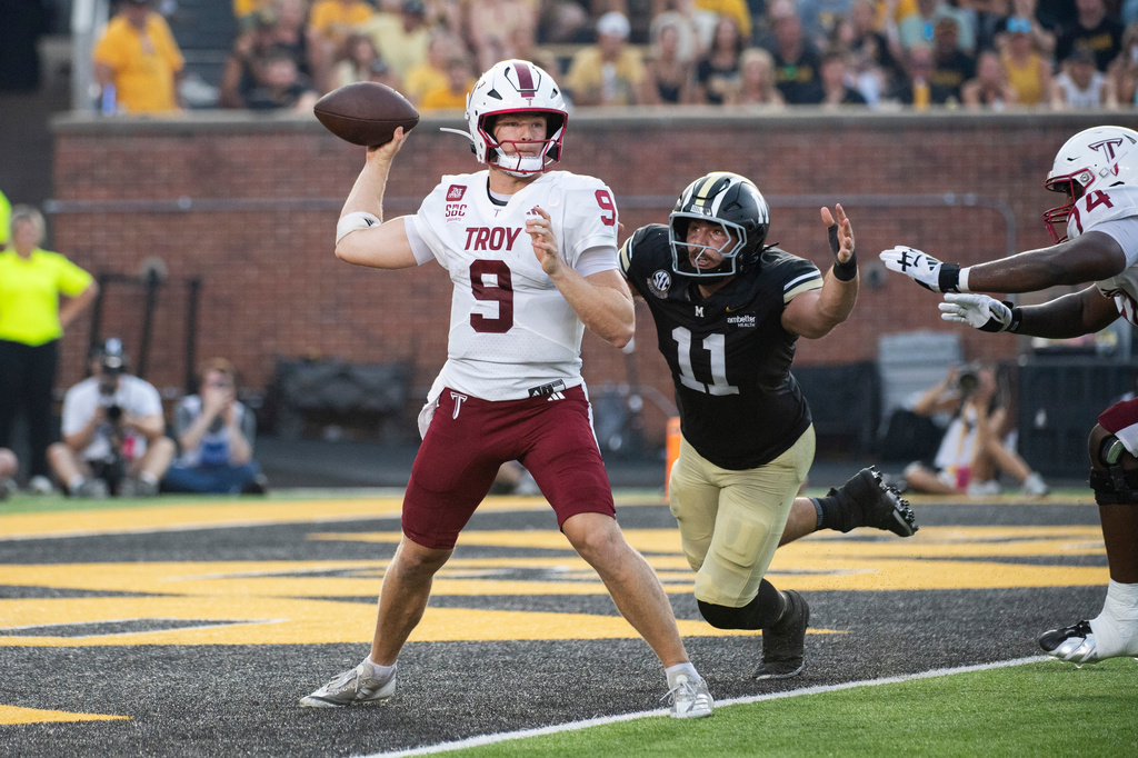 Troy quarterback Goose Crowder (9) looks to throw a pass as Missouri's Langden Kitchen (11) moves in during the first half of an NCAA college football game Saturday, Sept. 19, 2026, in Columbia, Mo. (AP Photo/LG Patterson)