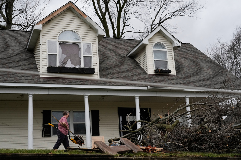 A volunteer works to clear up debris in the aftermath of a powerful storm that ripped through the area a day earlier, in Union City Mich., Saturday, March 7, 2026. (AP Photo/Nam Y. Huh)