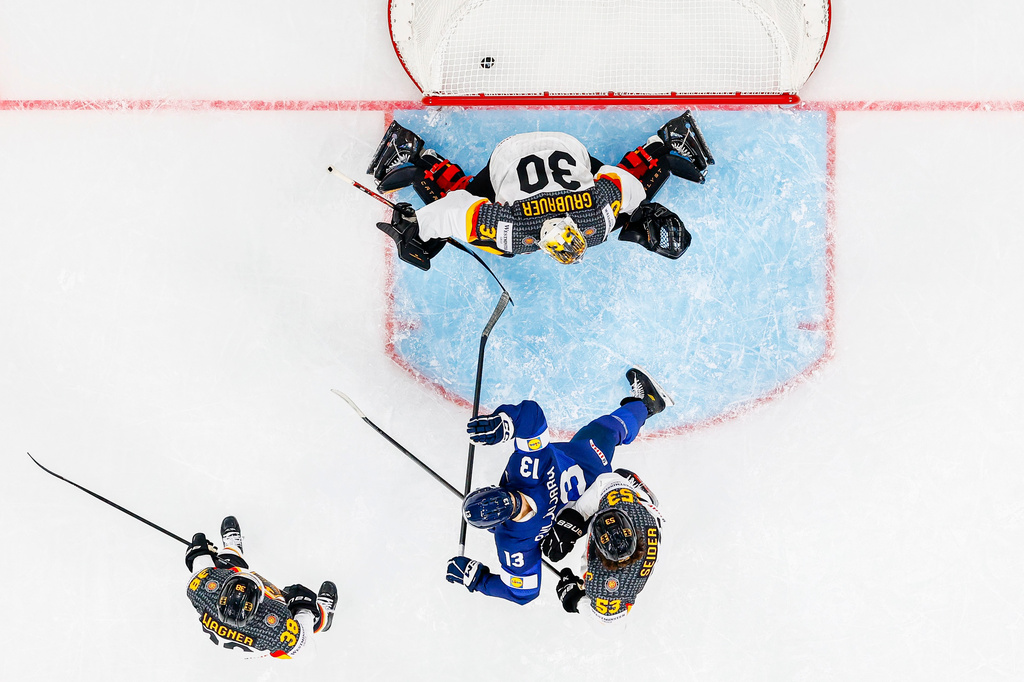 Germany's goaltender Philipp Grubauer, top, fails to save a goal by Finland's Anton Lundell, as Germany's Fabio Wagner, left, and Germany's Moritz Seider, right, vie with Finland's Jesse Puljujarvi, center, during the Group A preliminary round game between Finland and Germany at the men's ice hockey world championship in Zurich, Switzerland, Friday, May 15, 2026. (Michael Buholzer/Keystone via AP)