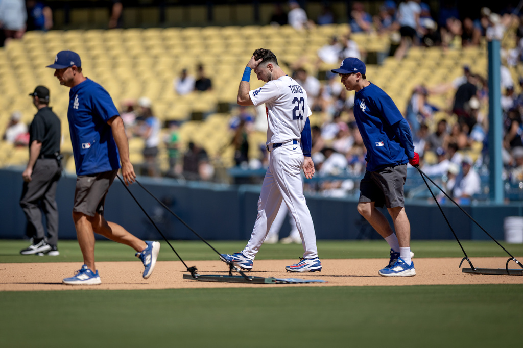 Los Angeles Dodgers' Kyle Tucker (23) walks to the outfield after grounding out during the seventh inning of a baseball game against the Milwaukee Brewers, Sunday, Aug. 16, 2026, in Los Angeles. (Eric Thayer/Los Angeles Times via AP)