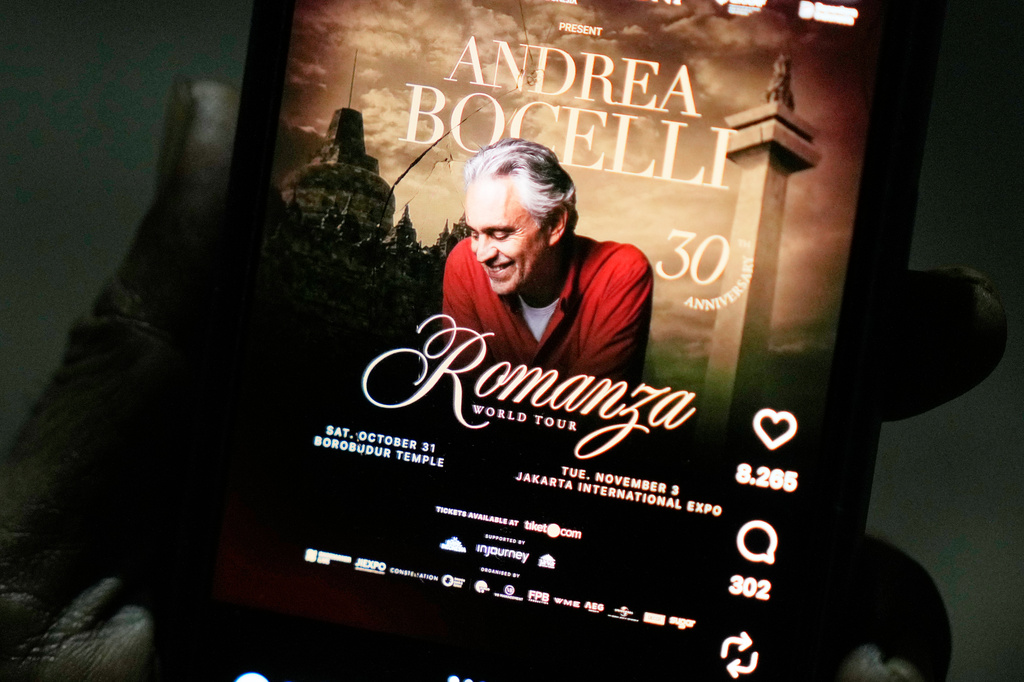 A man shows a social media promotional post for concerts by Italian tenor Andrea Bocelli on a mobile phone, in Jakarta, Indonesia, Wednesday, Oct. 14, 2026. (AP Photo/Dita Alangkara)