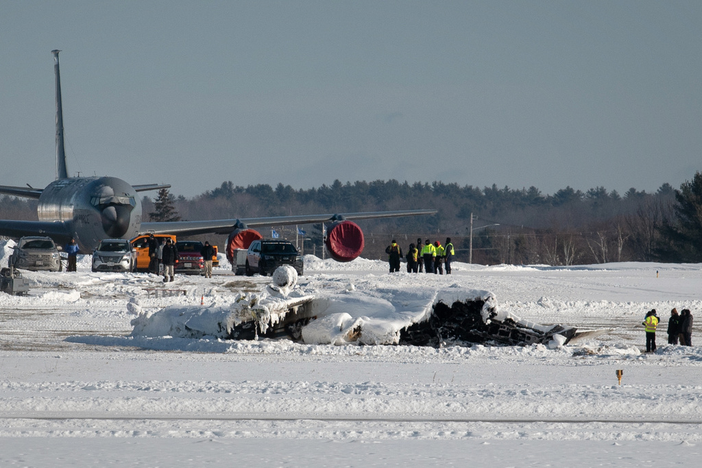 FILE - Investigators from the Federal Aviation Administration and National Transportation Safety Board investigate a plane crash at Bangor International Airport Wednesday, Jan. 28, 2026 in Bangor, Maine. (Linda Coan O'Kresik/The Bangor Daily News via AP, File)