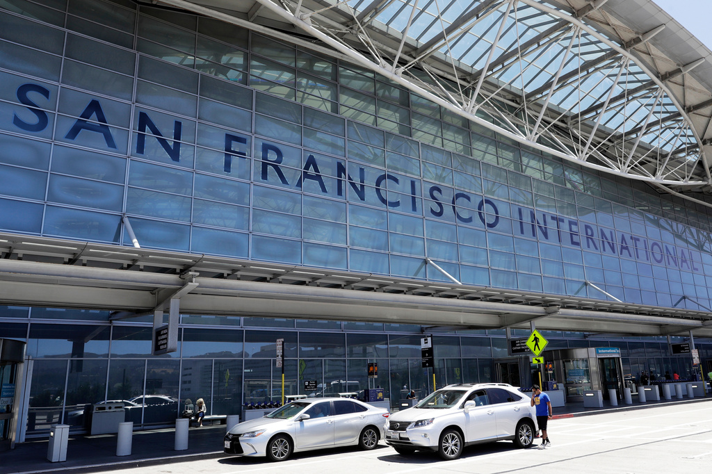FILE - Vehicles wait outside the international terminal at San Francisco International Airport, in San Francisco, July 11, 2017. (AP Photo/Marcio Jose Sanchez, File)