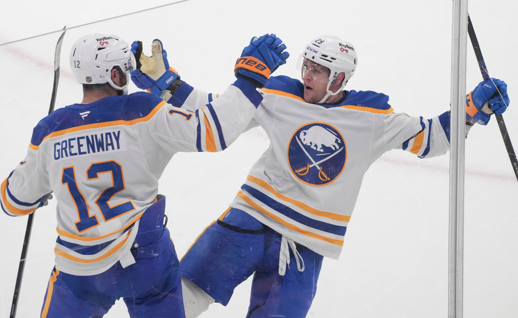 Buffalo Sabres' Beck Malenstyn, right, celebrates after his goal against the Montreal Canadiens with teammate Jordan Greenway (12) during first-period NHL hockey game action in Montreal, Thursday, Jan. 22, 2026. (Christinne Muschi/The Canadian Press via AP)