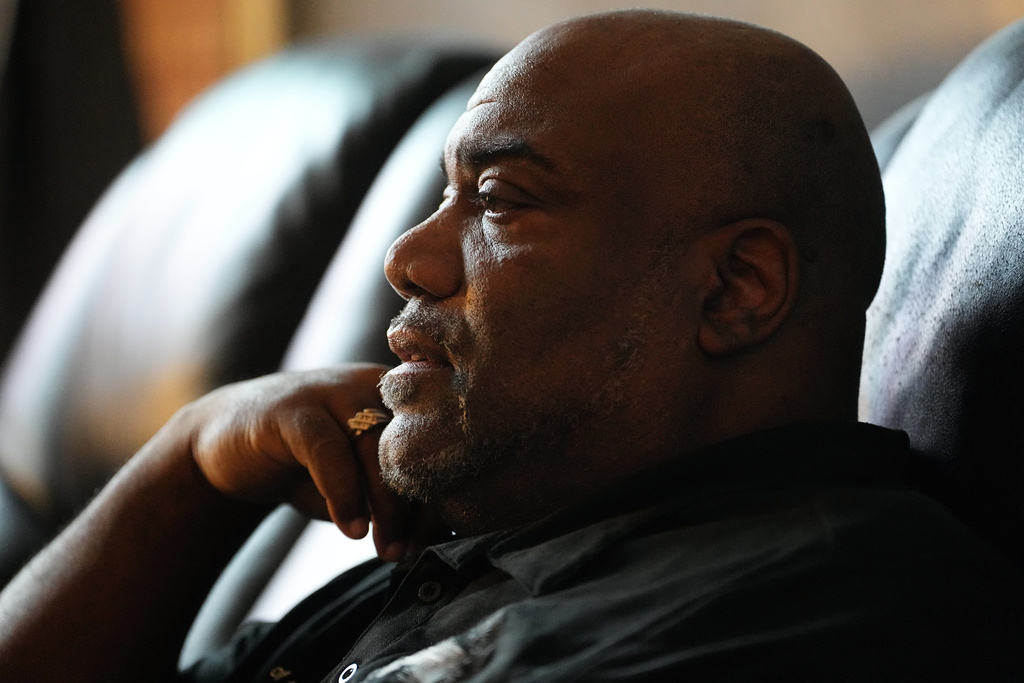 Ahmad Collins watches television in his home in Harrisburg, Pa., Thursday, Dec. 11, 2025. A city government worker and former Penn State linebacker, Collins has needed 10 hours a night of dialysis since a medical procedure left him with damaged kidneys late last year. (AP Photo/Matt Rourke)