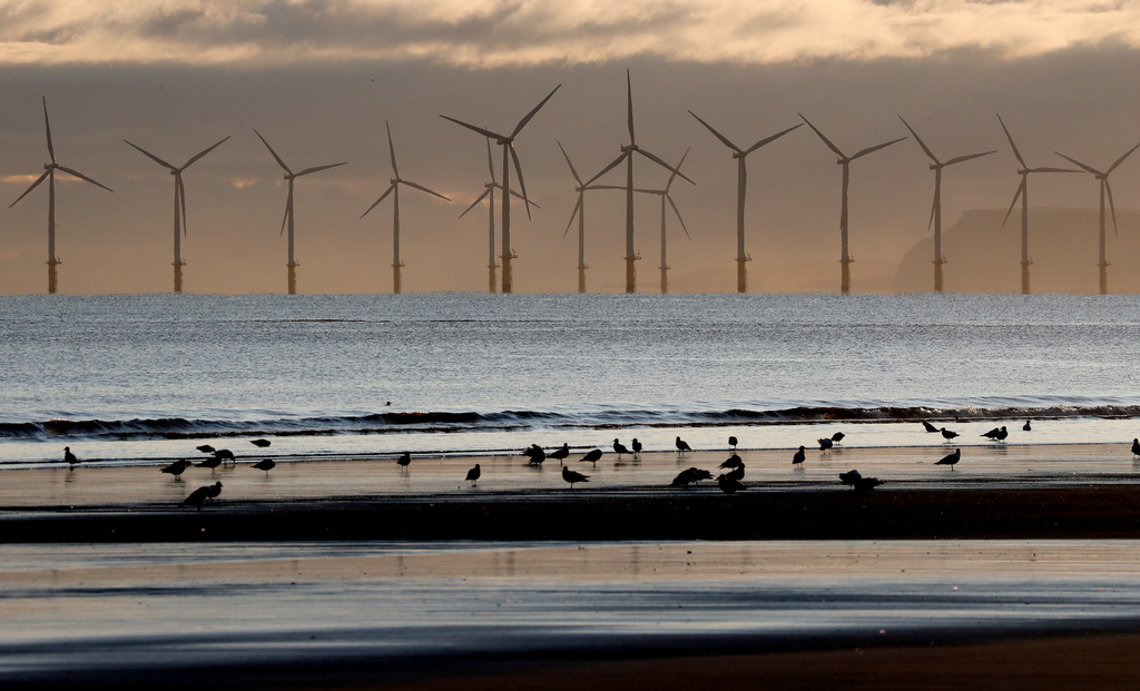 FILE - An offshore wind farm is visible from the beach in Hartlepool, England, Tuesday, Nov. 12, 2019. (AP Photo/Frank Augstein, File)