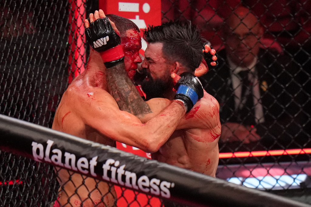 Mike Perry, of the United States, right, fights Nate Diaz, of the United States, during their welterweight mixed martial arts fight Saturday, May 16, 2026, in Inglewood, Calif. (AP Photo/Jae C. Hong )