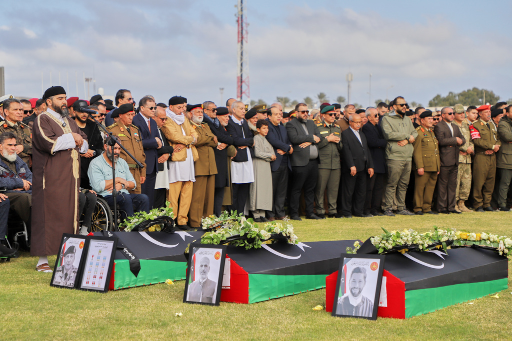 People attend funeral prayers for Gen. Muhammad Ali Ahmad al-Haddad, coffin at left, in Misrata, Libya, Sunday, Dec. 28, 2025, who was killed with others in a plane crash on Tuesday after taking off from Ankara. (AP Photo/Yousef Murad)