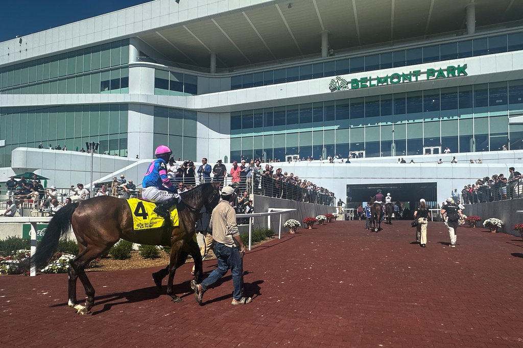In this photo made with a smartphone, jockeys ride their horses into the newly-opened Belmont Park in Elmont, N.Y., on Friday, Sept. 18, 2026. (AP Photo/Stephen Whyno)