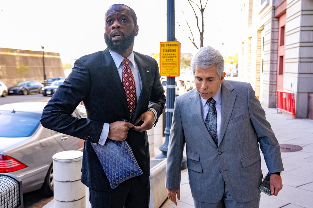 FILE - Prakazrel "Pras" Michel, a member of the 1990s hip-hop group the Fugees, left, accompanied by defense lawyer David Kenner arrives at federal court April 3, 2023, in Washington. (AP Photo/Andrew Harnik, File)