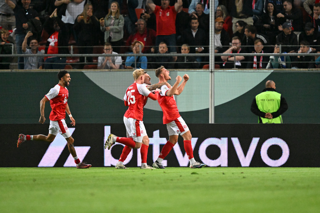 Hallescher's Vin Kastull, right, celebrates scoring with teammates during the German soccer cup match between Hallescher FC and FC Schalke 04 in Halle, Germany, Monday Aug. 24, 2026. (Hendrik Schmidt/dpa via AP)
