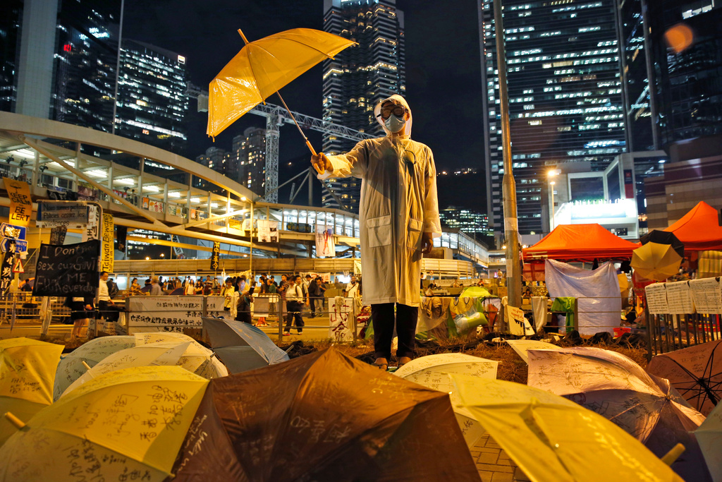 FILE - A protester holds an umbrella up during a rally on a main road in the occupied areas outside government headquarters in Hong Kong's Admiralty, Oct. 9, 2014. (AP Photo/Kin Cheung, File)